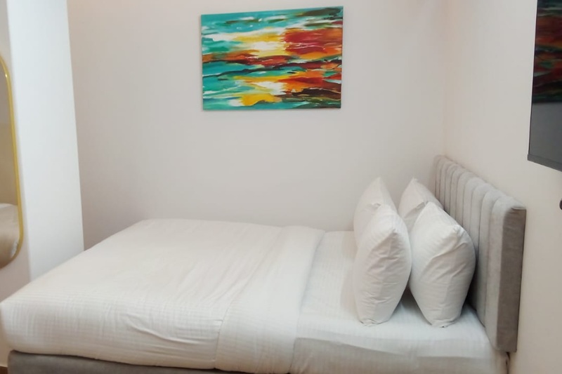 hotel room with grey curtain, brown floor