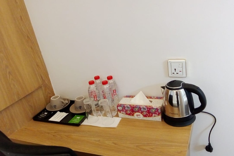 hotel room with grey curtain, brown floor