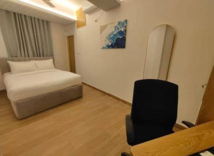 hotel room with grey curtain, brown floor