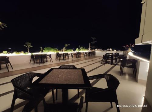colorful light, round tables, chairs on a rooftop cafe