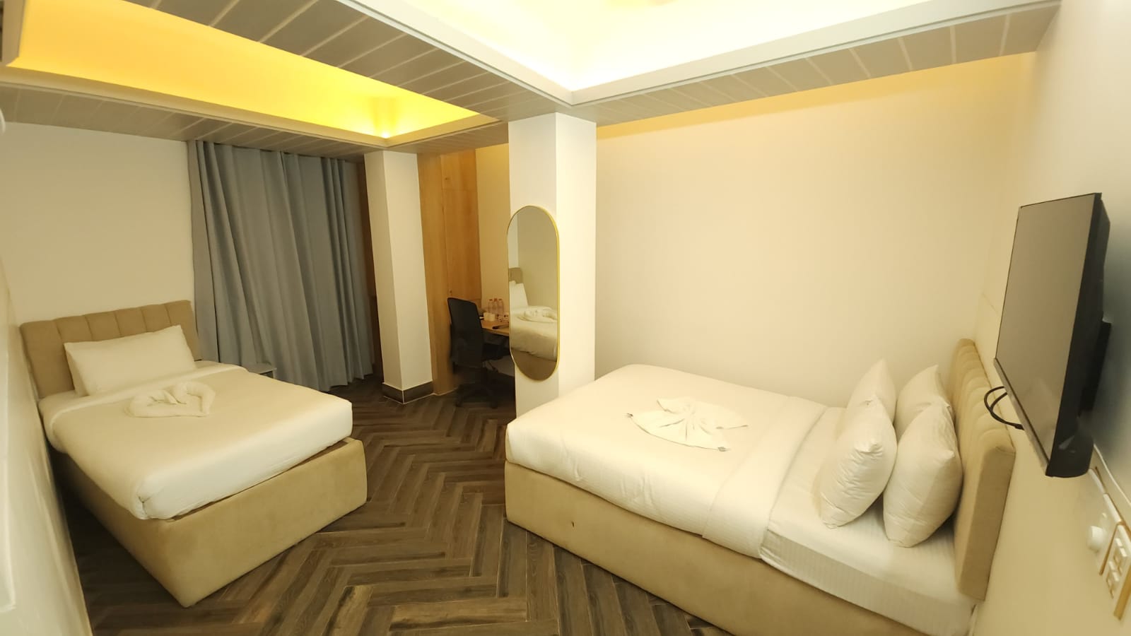 hotel room with grey curtain, brown floor